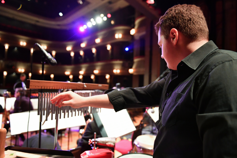 A student playing percussion in the RCM's Jazz Orchestra in the Britten Theatre.